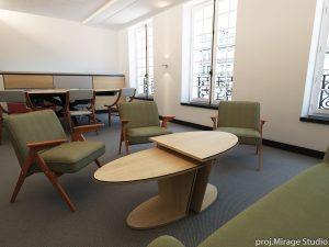 Elegancka strefa spotkań w biurze obsługi klienta w Paryżu, z fotelami w kolorze oliwkowej zieleni i designerskim stolikiem.